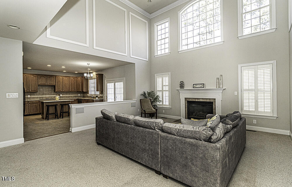 9244 Palm Bay Circle Raleigh, NC 27617 - Photo 11 of 29 a living room with furniture a fireplace and a window