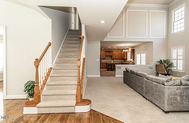 a living room with furniture and a chandelier