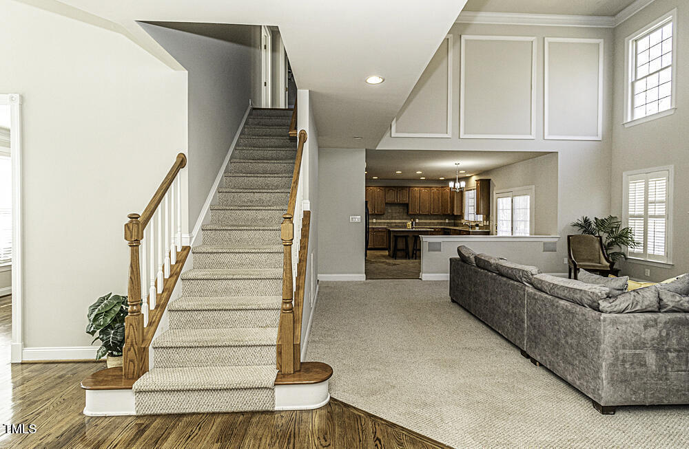 9244 Palm Bay Circle Raleigh, NC 27617 - Photo 12 of 29 a living room with furniture and a chandelier