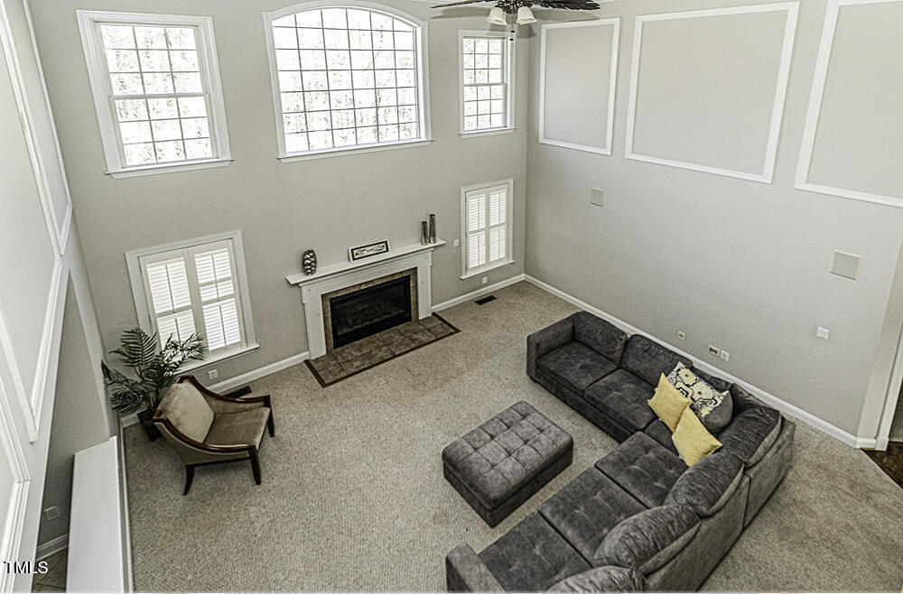 9244 Palm Bay Circle Raleigh, NC 27617 - Photo 14 of 29 a living room with furniture and a fireplace