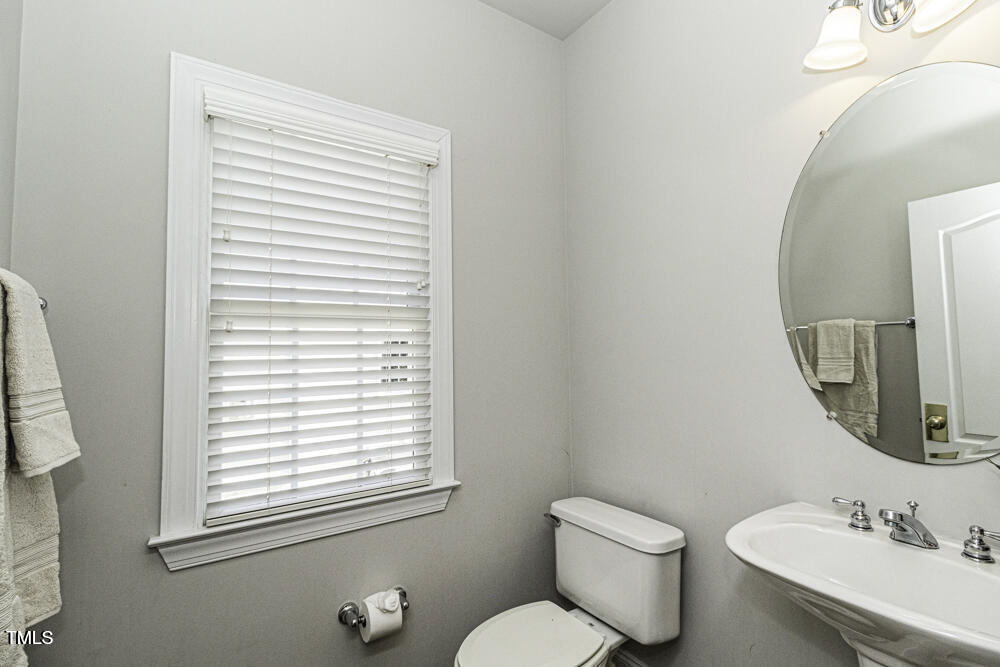 9244 Palm Bay Circle Raleigh, NC 27617 - Photo 17 of 29 a bathroom with a toilet a sink and a mirror