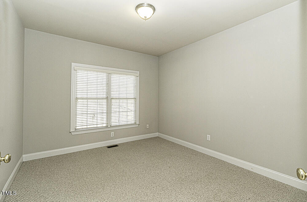 9244 Palm Bay Circle Raleigh, NC 27617 - Photo 18 of 29 an empty room with a window