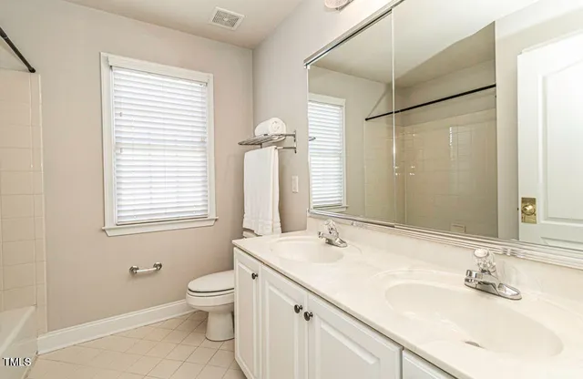 a bathroom with a granite countertop sink toilet a large mirror and shower