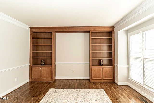 a room with walk in closet and wooden floor