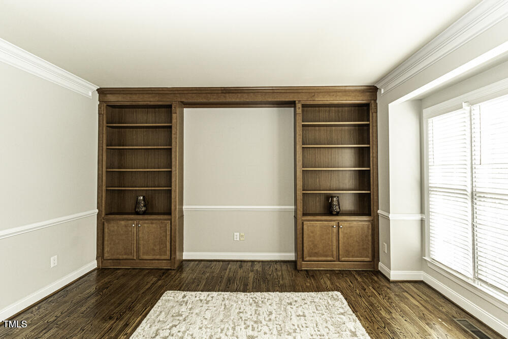9244 Palm Bay Circle Raleigh, NC 27617 - Photo 8 of 29 a room with walk in closet and wooden floor
