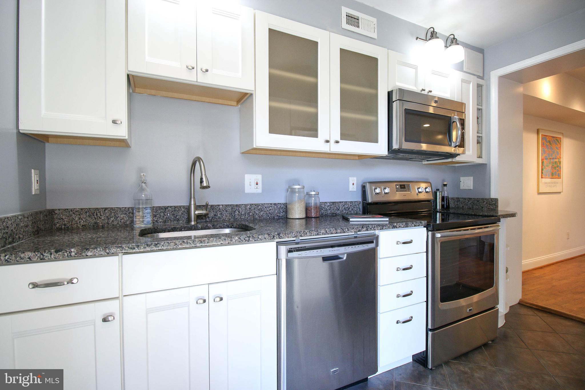 103 17th Street Southeast Washington, DC 20003 - Photo 12 of 26 a kitchen with stainless steel appliances granite countertop a sink stove and microwave