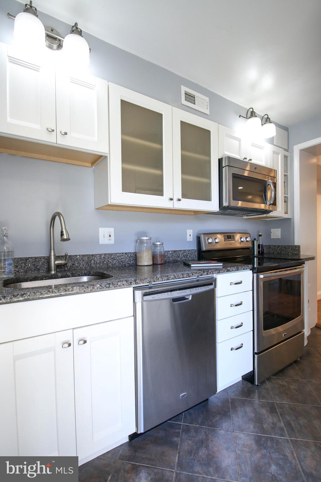 103 17th Street Southeast Washington, DC 20003 - Photo 13 of 26 a kitchen with granite countertop a sink stainless steel appliances and cabinets