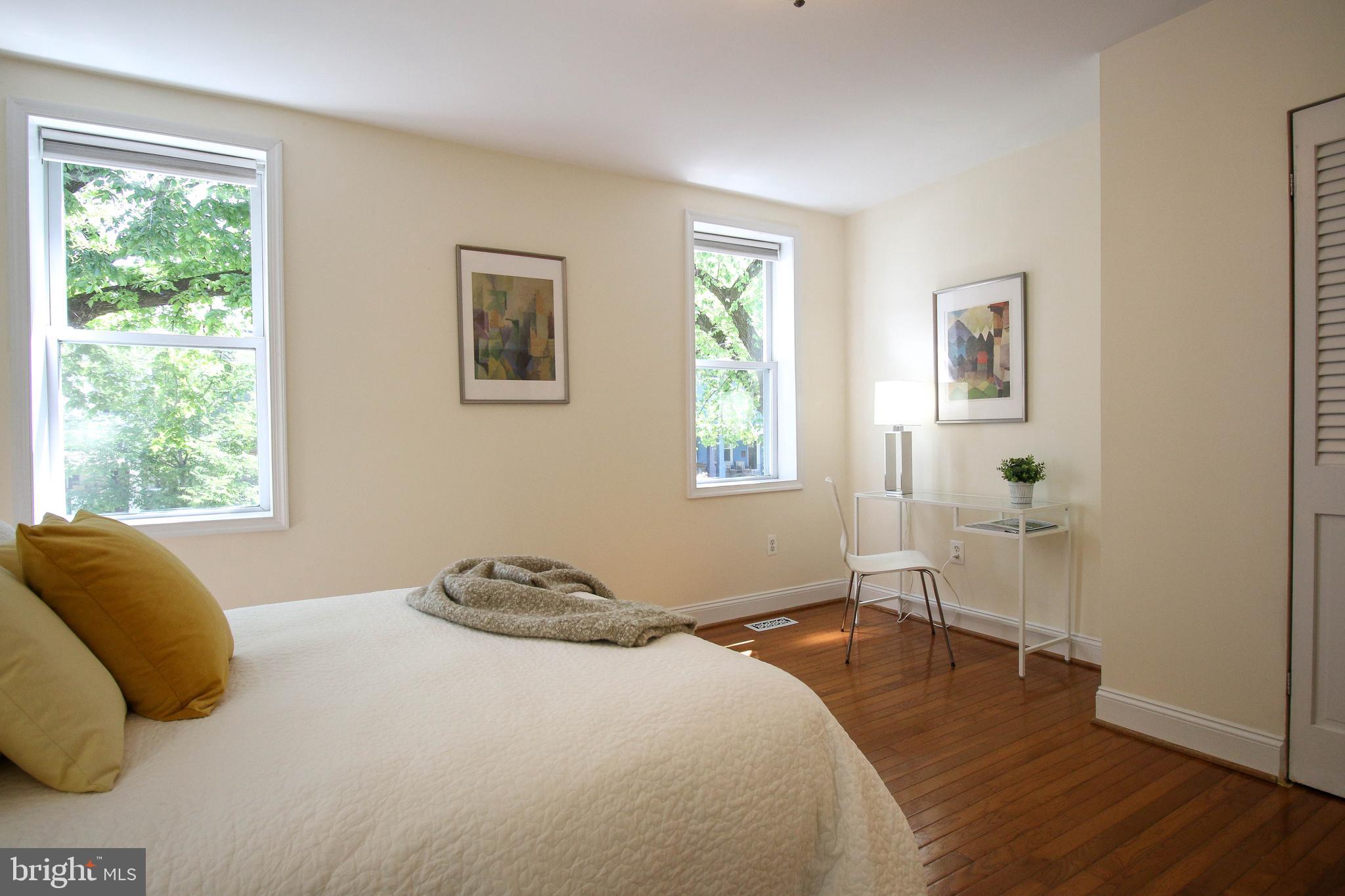 103 17th Street Southeast Washington, DC 20003 - Photo 16 of 26 a bedroom with a bed and wooden floor