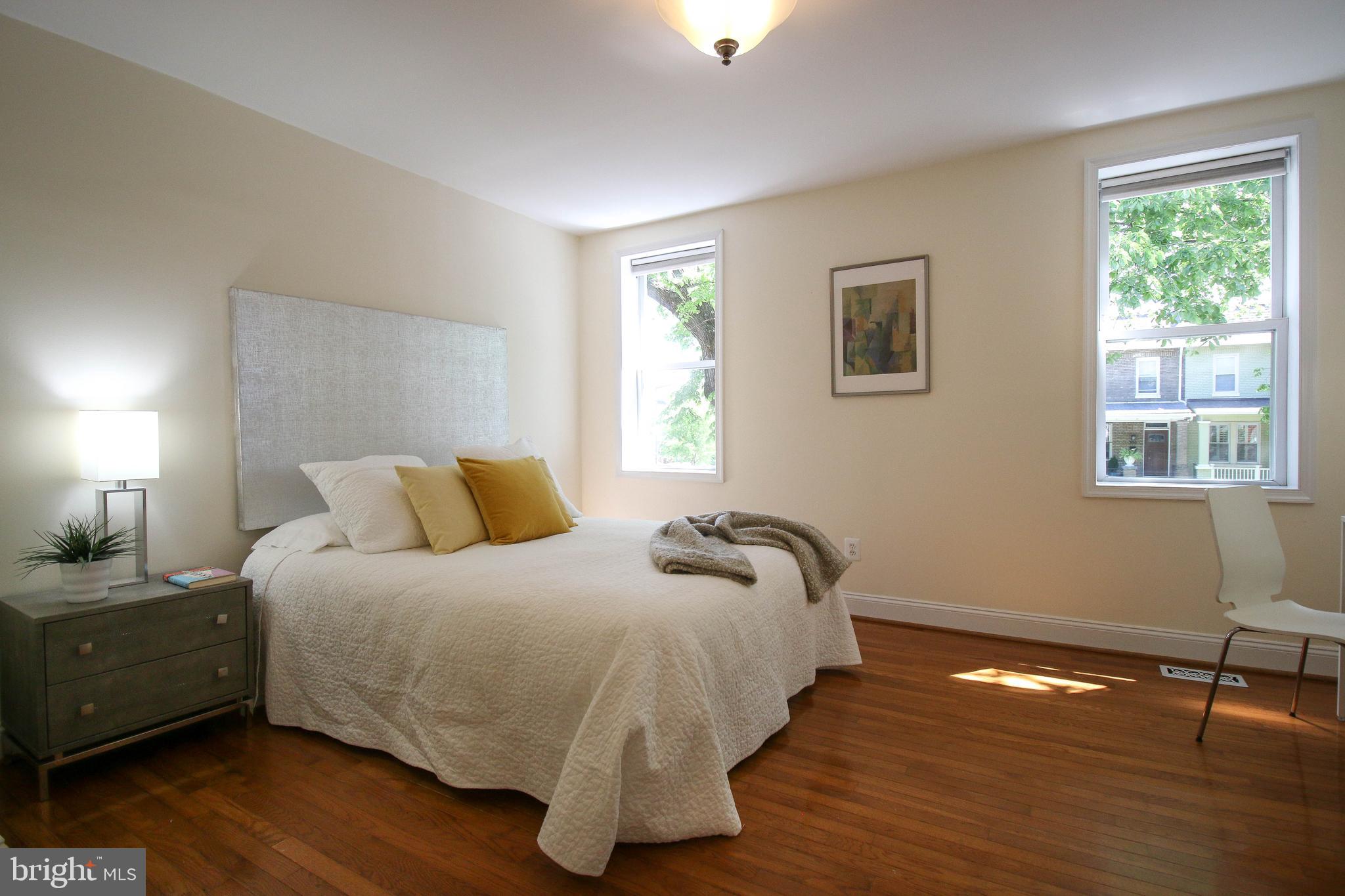 103 17th Street Southeast Washington, DC 20003 - Photo 17 of 26 a bedroom with a bed and wooden floor