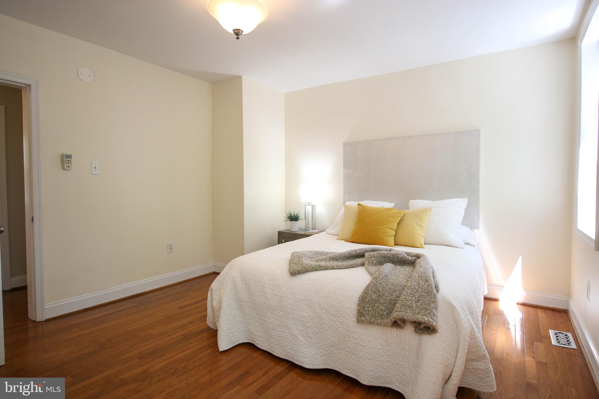 103 17th Street Southeast Washington, DC 20003 - Photo 18 of 26 a bedroom with a bed and wooden floor