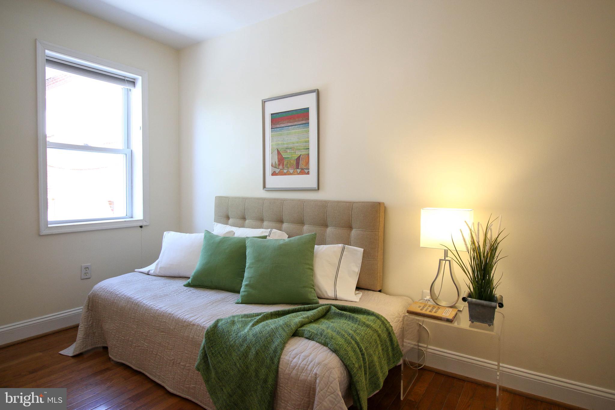 103 17th Street Southeast Washington, DC 20003 - Photo 21 of 26 a bedroom with a bed and a window