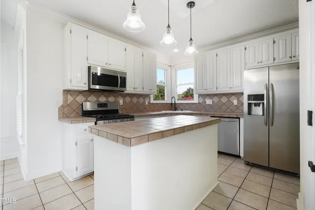 a kitchen with a sink window and cabinets