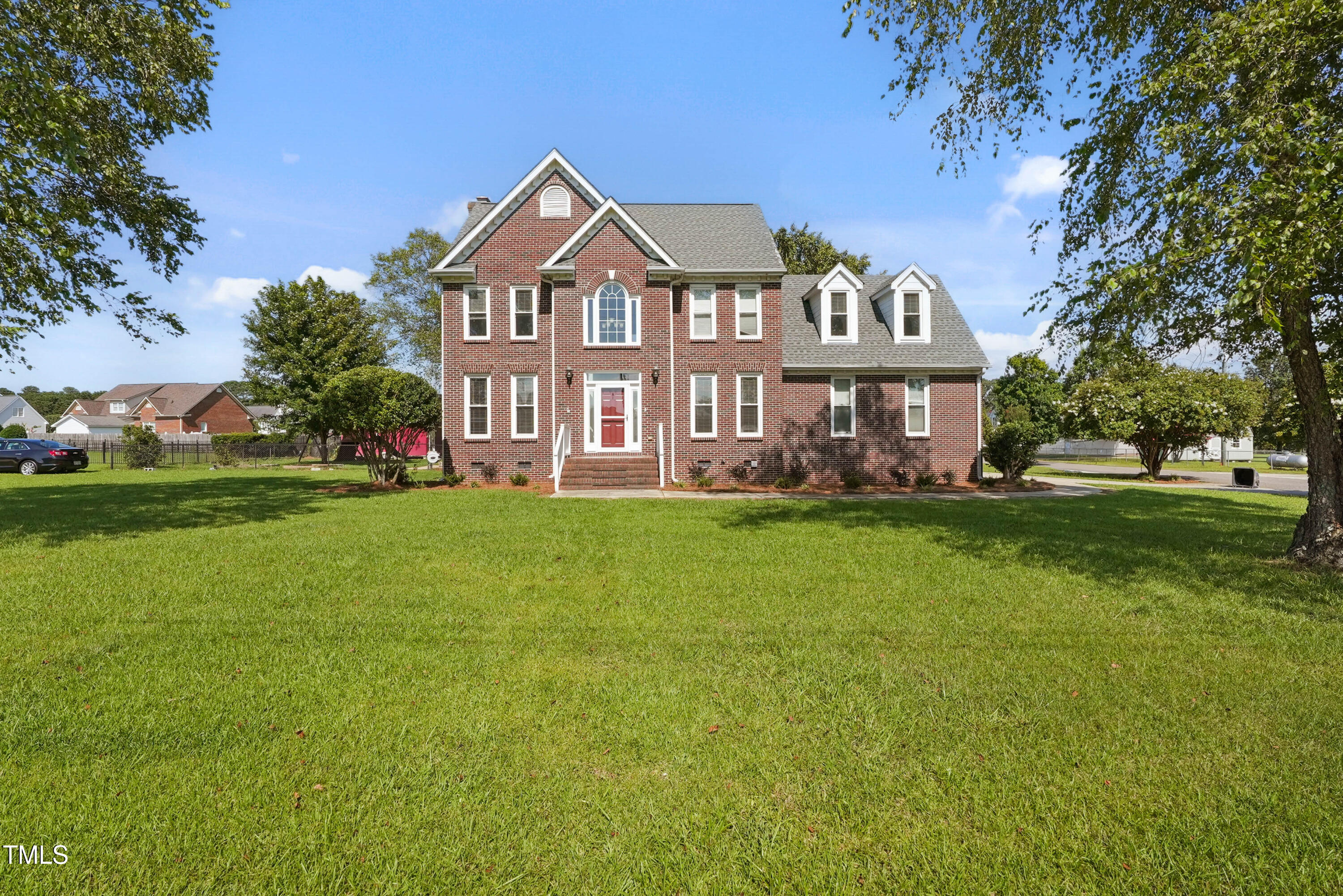 1010 Warren Road Erwin, NC 28339 - Photo 2 of 54 a front view of a house with a garden and trees