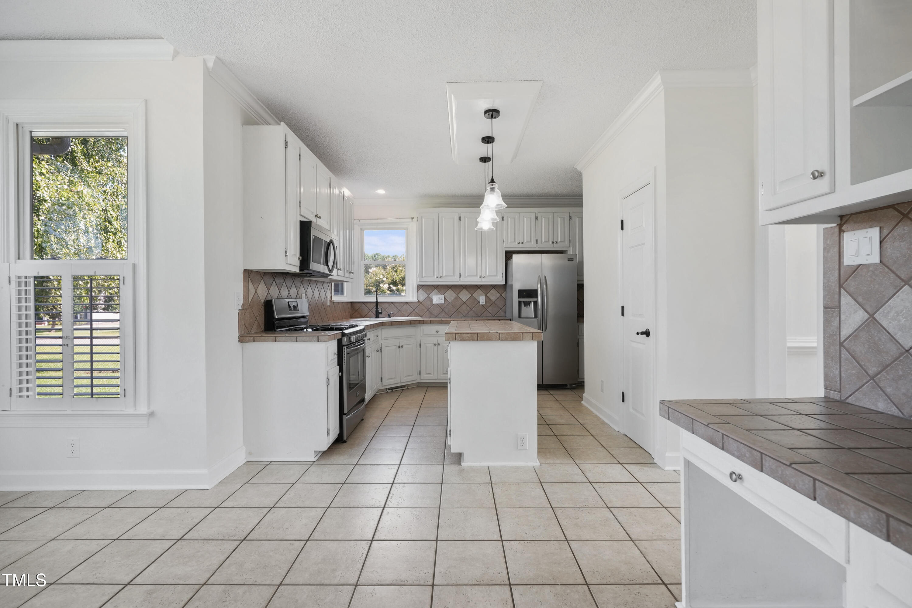1010 Warren Road Erwin, NC 28339 - Photo 21 of 54 a kitchen with a sink a stove a microwave and cabinets