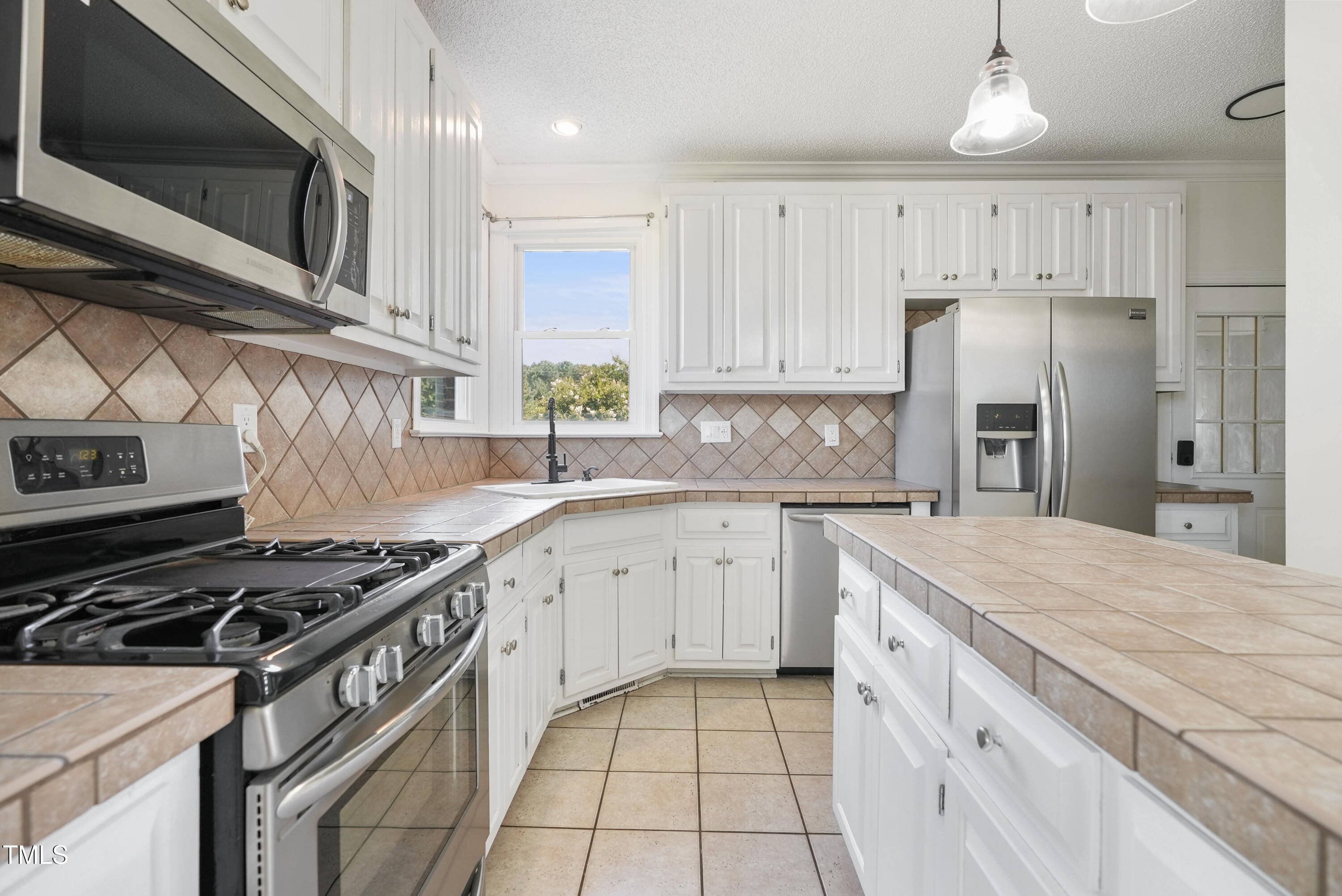 1010 Warren Road Erwin, NC 28339 - Photo 23 of 54 a kitchen with granite countertop a stove sink and refrigerator