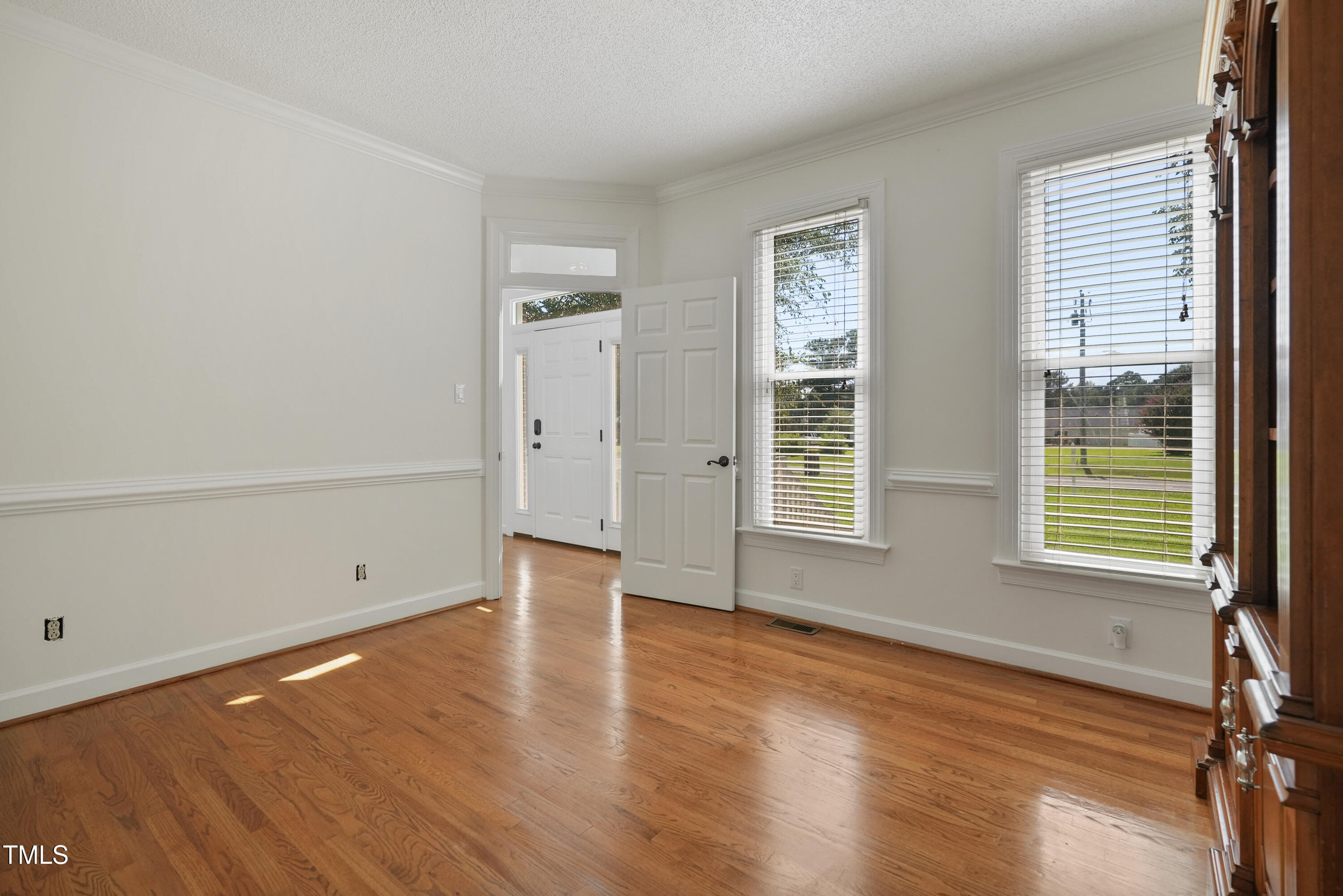 1010 Warren Road Erwin, NC 28339 - Photo 30 of 54 an empty room with wooden floor and windows