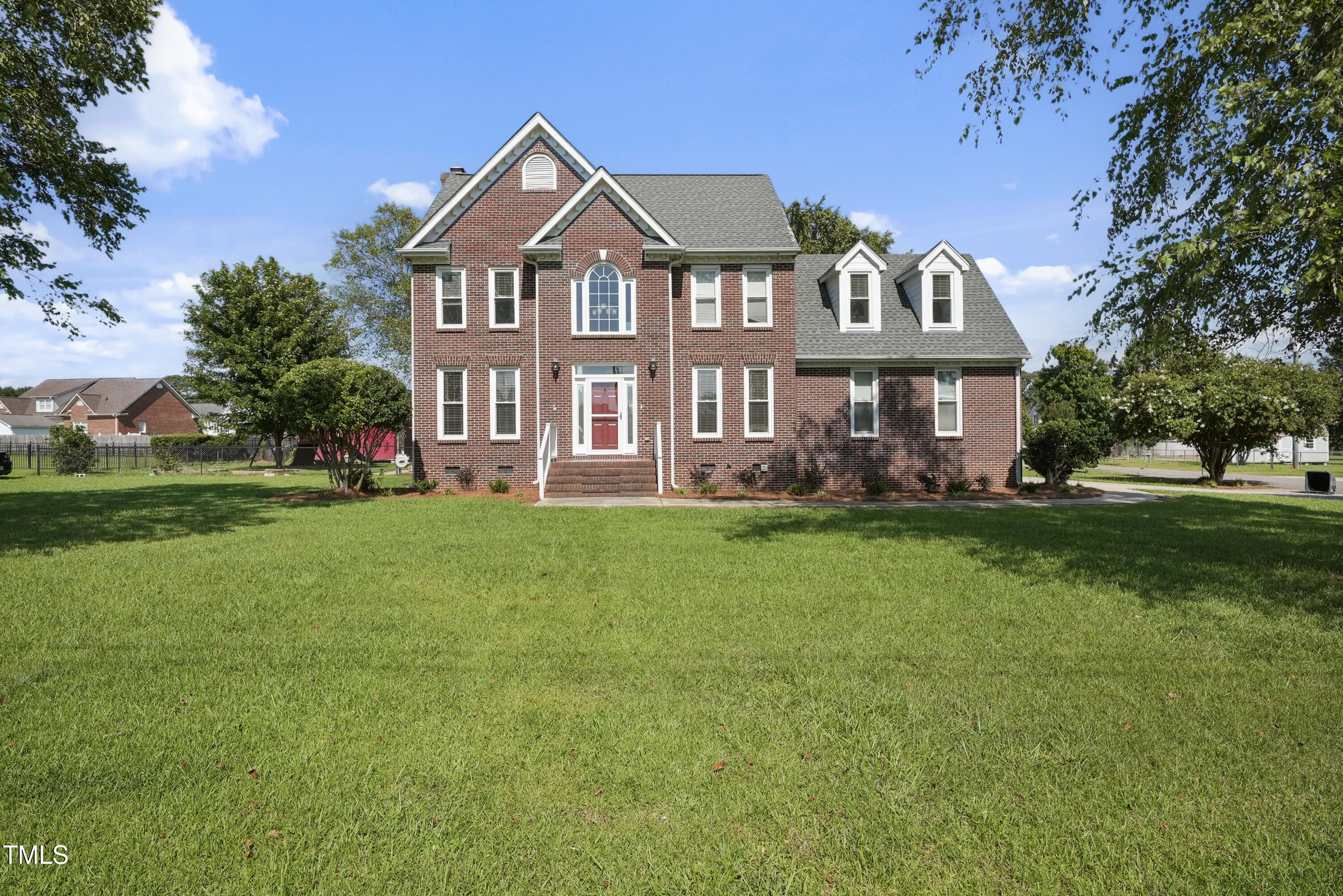 1010 Warren Road Erwin, NC 28339 - Photo 5 of 54 a front view of a house with a garden and trees