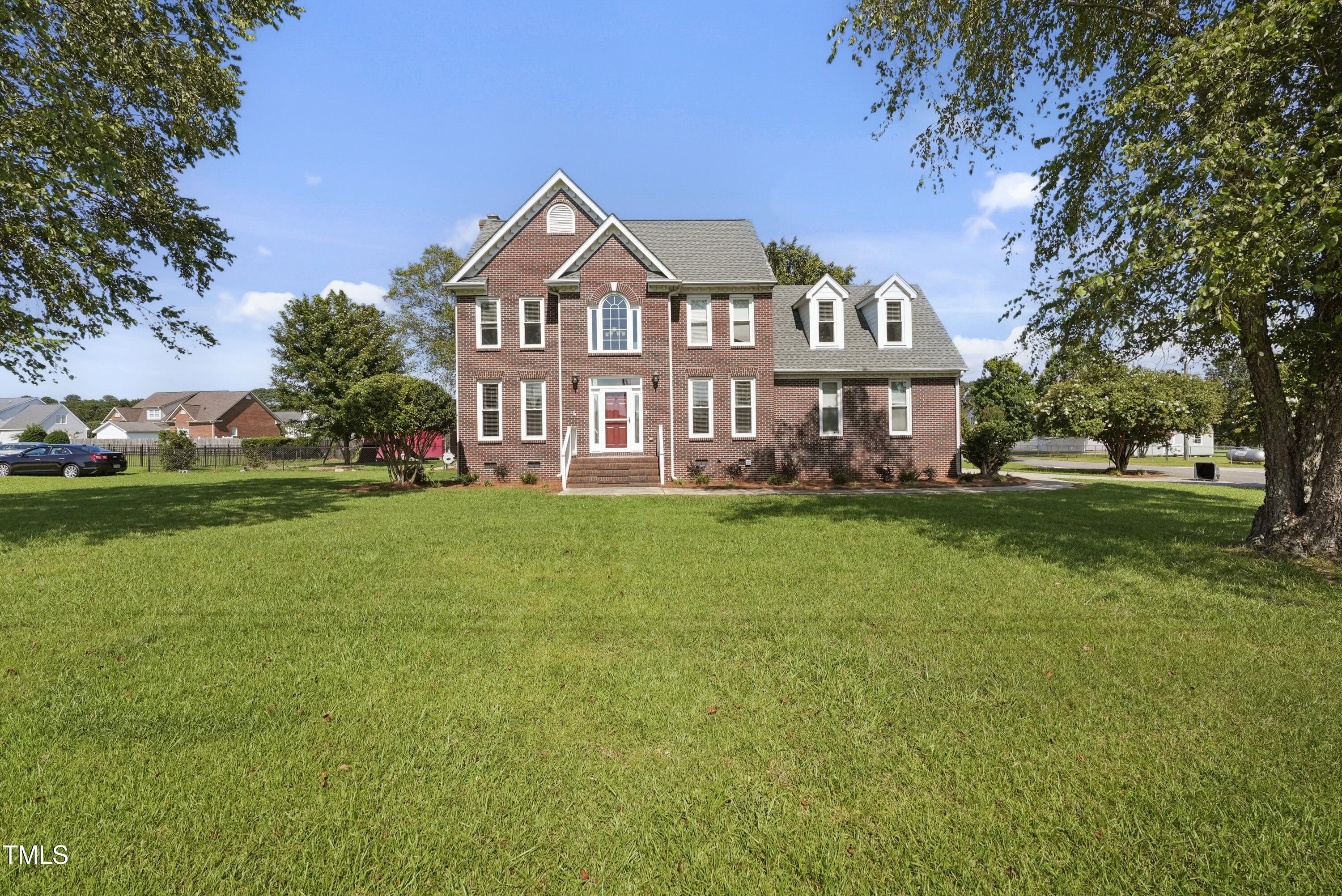 1010 Warren Road Erwin, NC 28339 - Photo 9 of 54 a front view of a house with garden and trees
