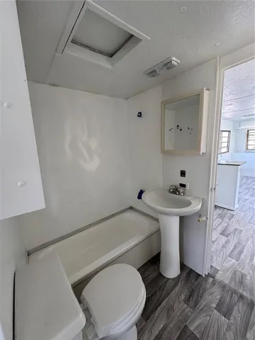 a bathroom with a sink toilet and a mirror