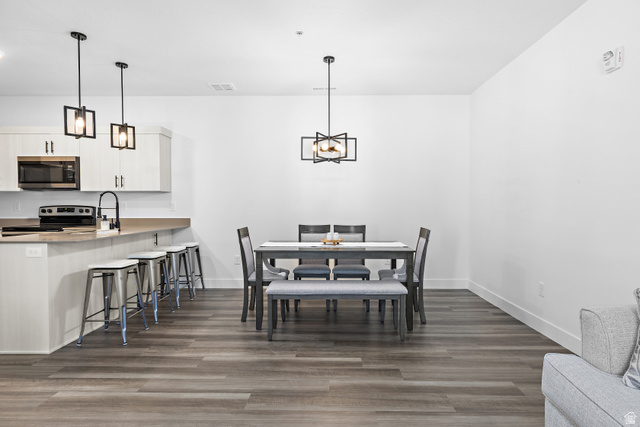 4735 Alder Drive, Unit F101 Mapleton, UT 84664 - Photo 8 of 30 Dining room with dark wood-style floors and hanging lights
