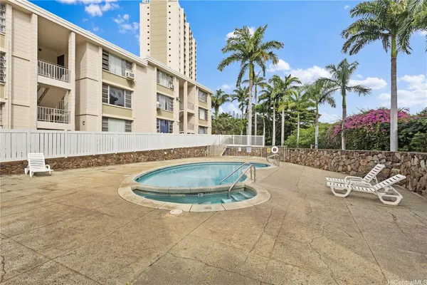 a swimming pool with outdoor seating and yard