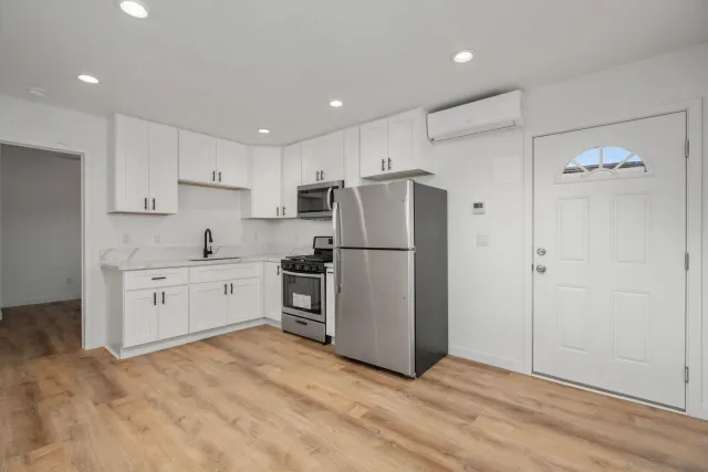 a bathroom with a sink a toilet and mirror