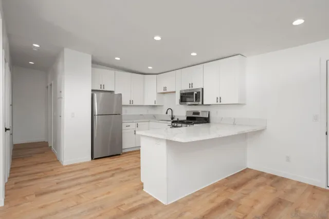 a kitchen with cabinets stainless steel appliances and a sink