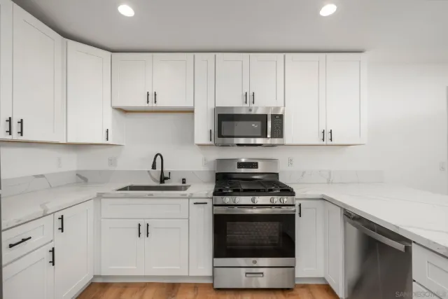 a kitchen with a sink and a refrigerator