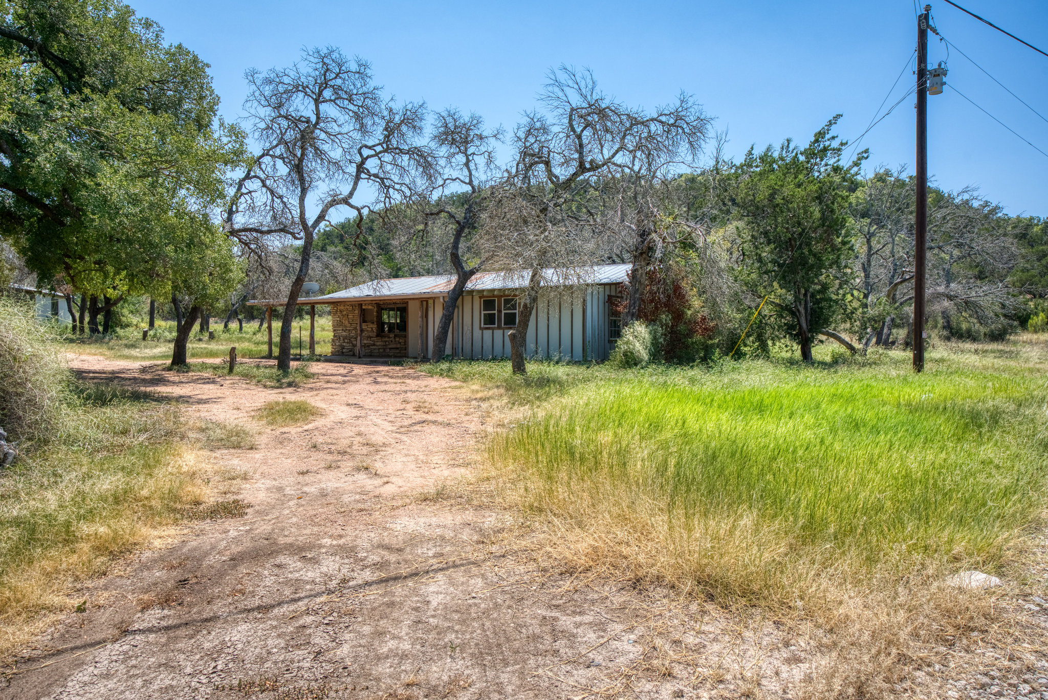 51 D S Road Fredericksburg, TX 78624 - Photo 11 of 19 View of front of house with board and batten siding, a metal roof, and driveway