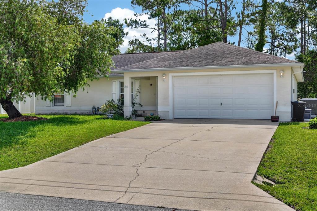 80 Roxboro Drive Palm Coast, FL 32164 - Photo 28 of 39 a front view of house with yard