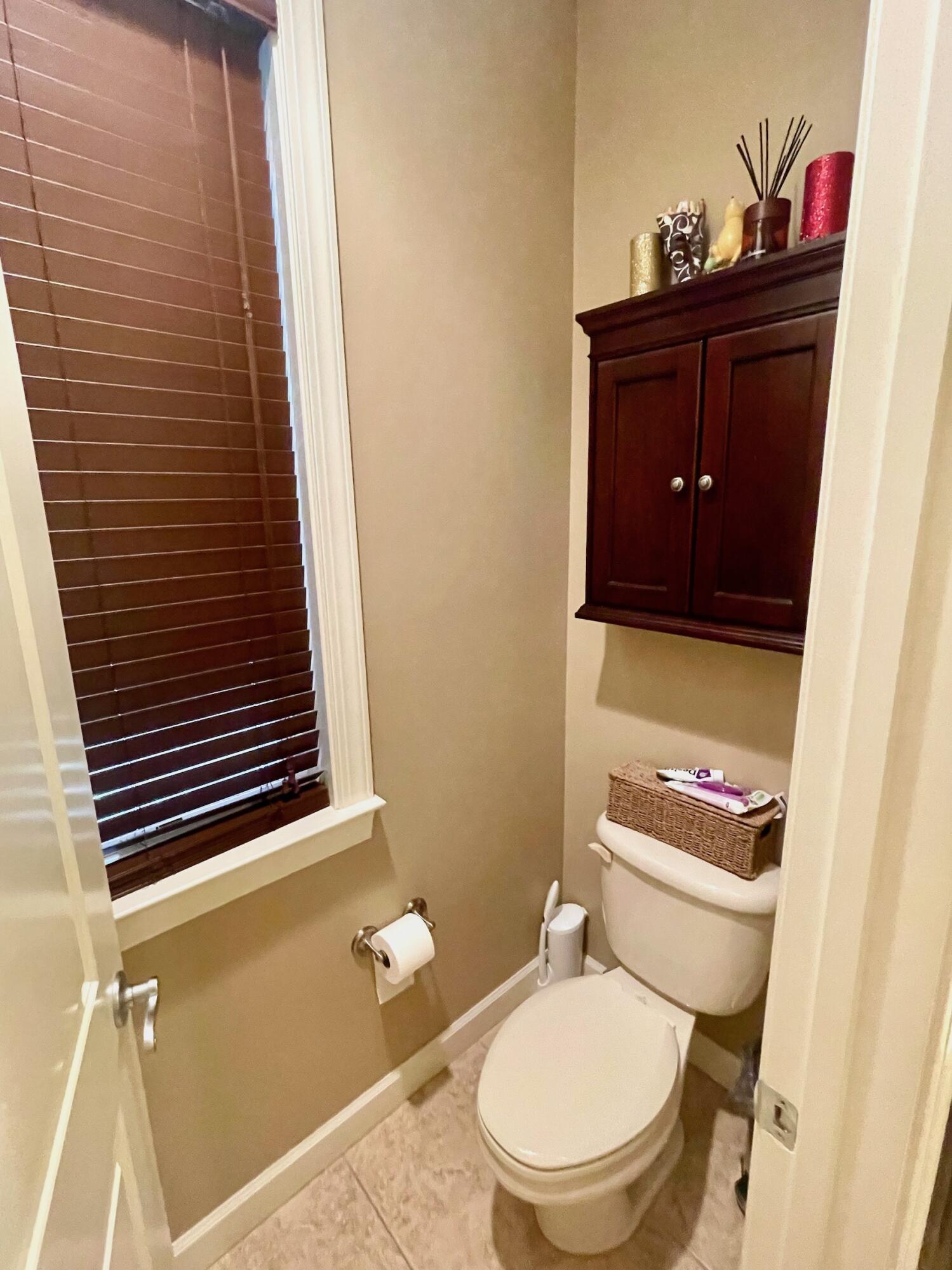 184 South Zander Way Santa Rosa Beach, FL 32459 - Photo 16 of 36 a bathroom with a toilet a sink and mirror