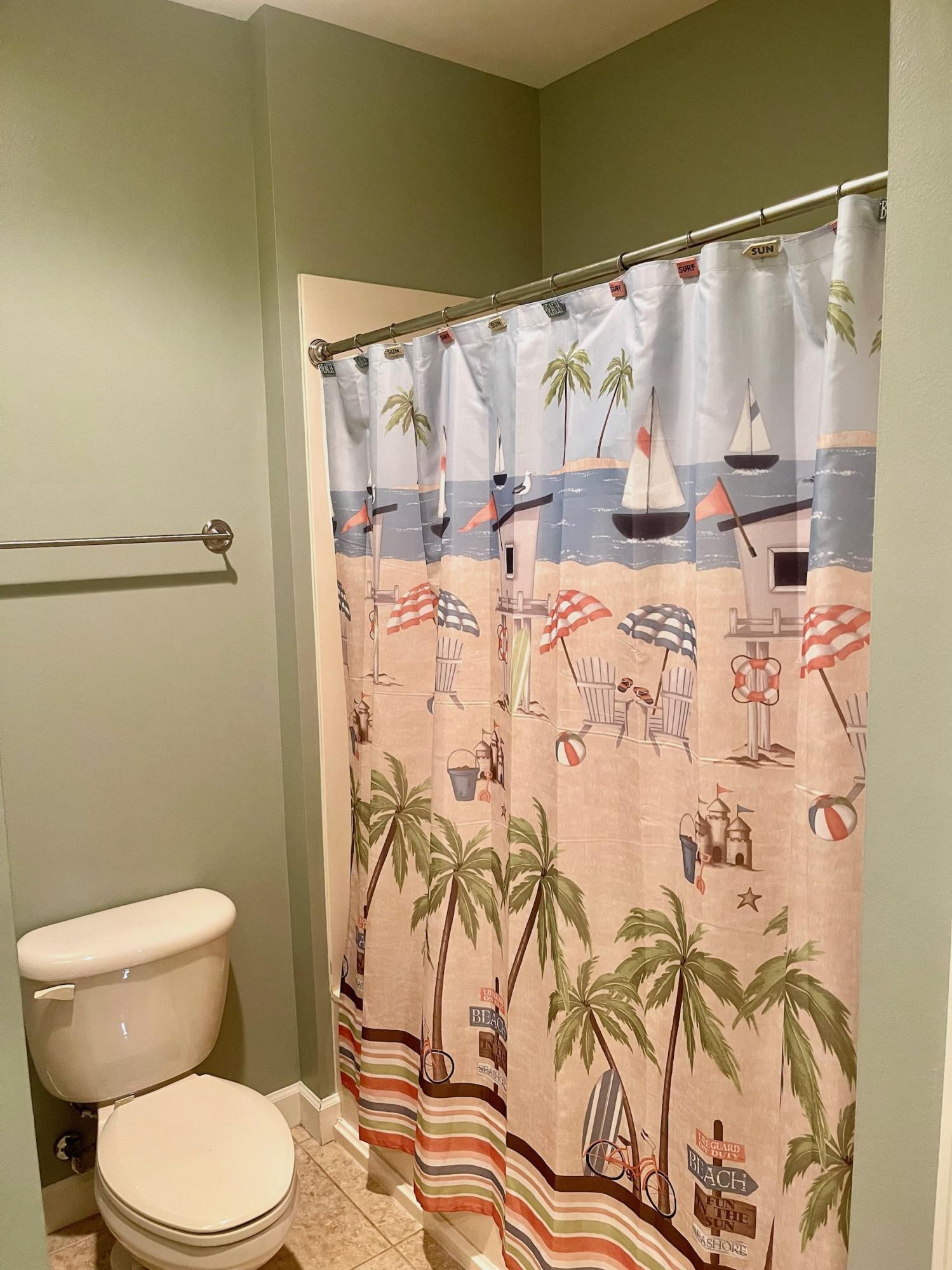 184 South Zander Way Santa Rosa Beach, FL 32459 - Photo 22 of 36 a white toilet sitting next to a shower curtain