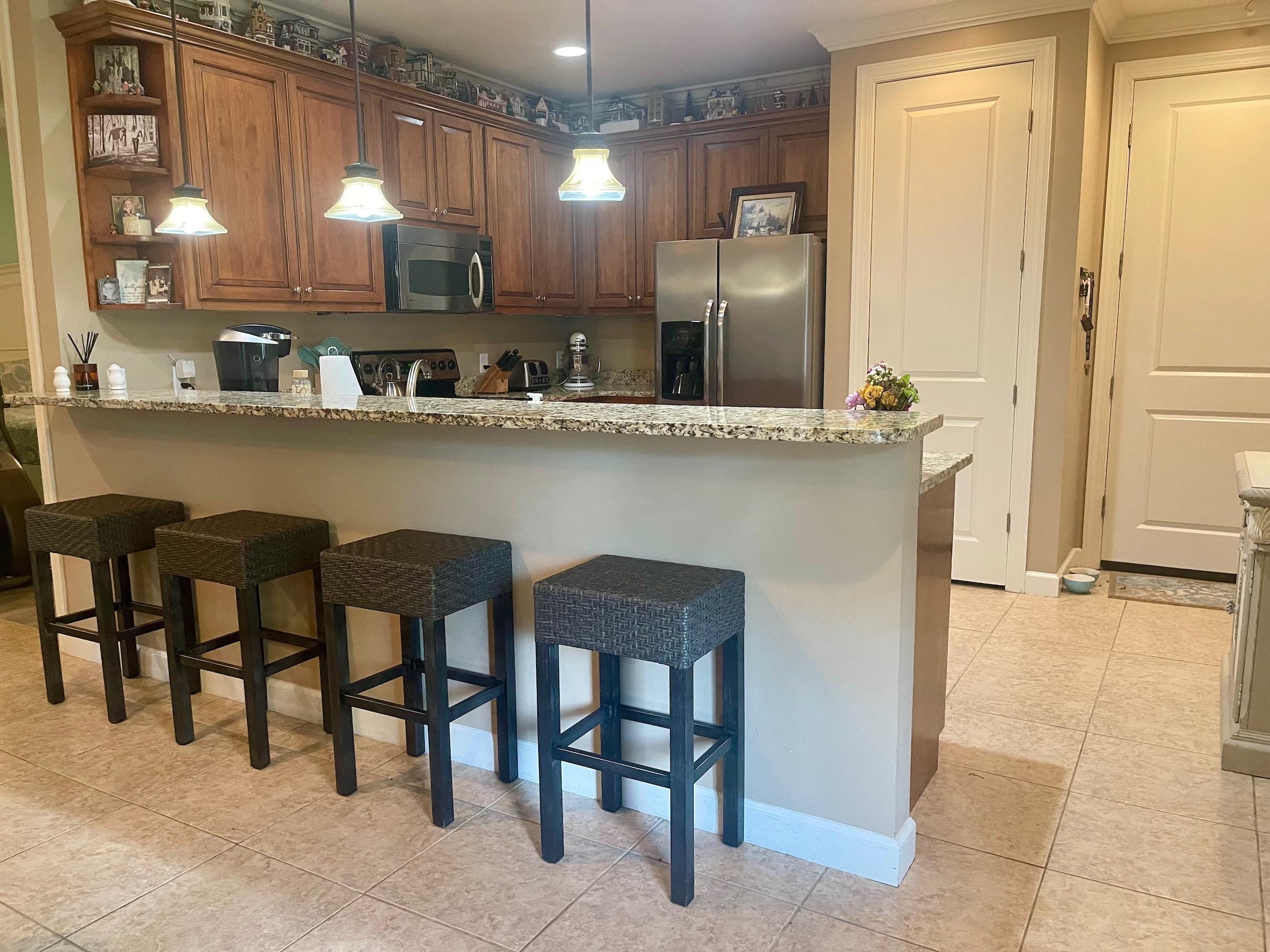 184 South Zander Way Santa Rosa Beach, FL 32459 - Photo 7 of 36 a kitchen with cabinets and chairs