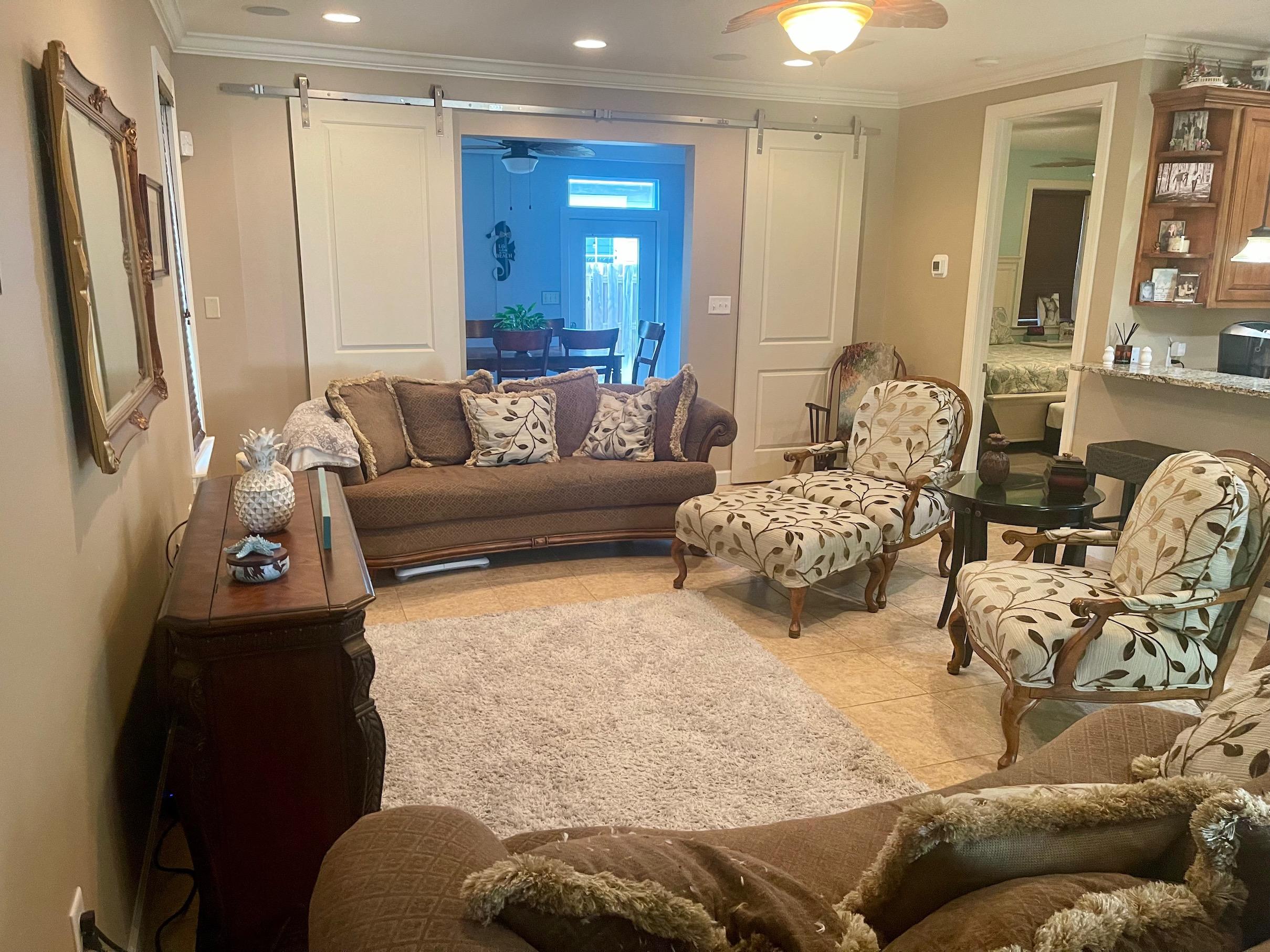 184 South Zander Way Santa Rosa Beach, FL 32459 - Photo 10 of 36 a living room with furniture and a large mirror