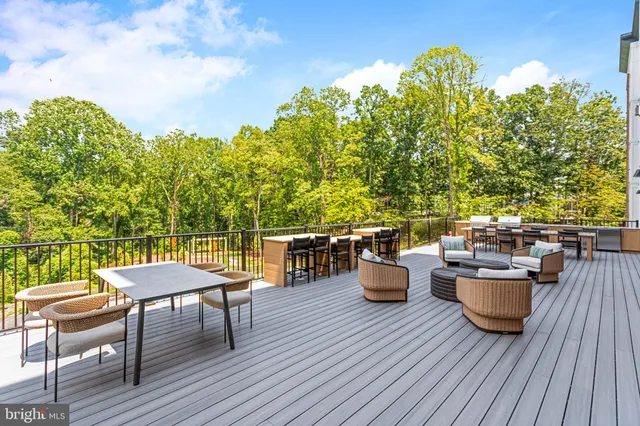 a view of a deck with table and chairs and wooden floor
