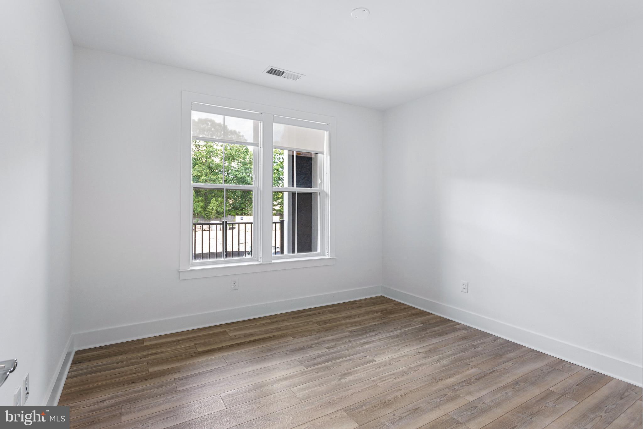 78 Old Mill Bottom Road North, Unit 107 Annapolis, MD 21409 - Photo 23 of 39 an empty room with wooden floor and windows