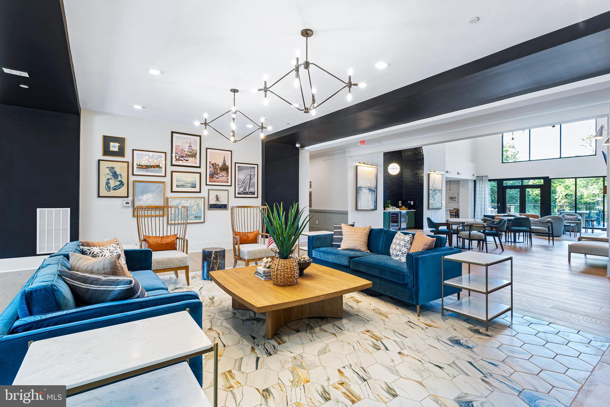 78 Old Mill Bottom Road North, Unit 107 Annapolis, MD 21409 - Photo 3 of 39 a living room with furniture a rug and a chandelier