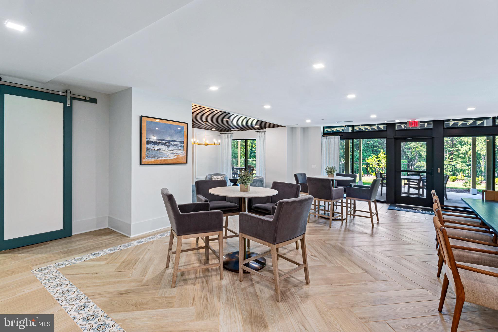 78 Old Mill Bottom Road North, Unit 107 Annapolis, MD 21409 - Photo 5 of 39 a view of a dining room with furniture and wooden floor