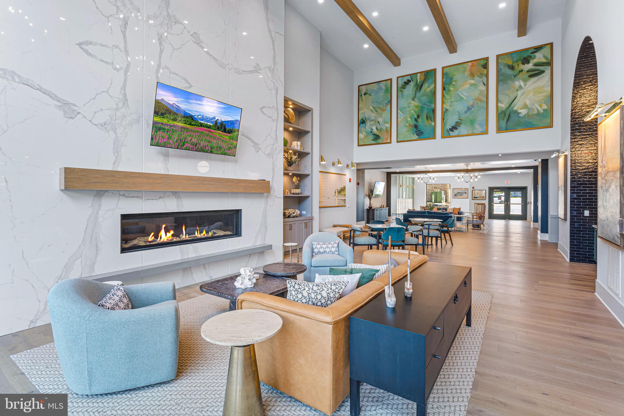 78 Old Mill Bottom Road North, Unit 107 Annapolis, MD 21409 - Photo 8 of 39 a living room with fireplace furniture and a large window
