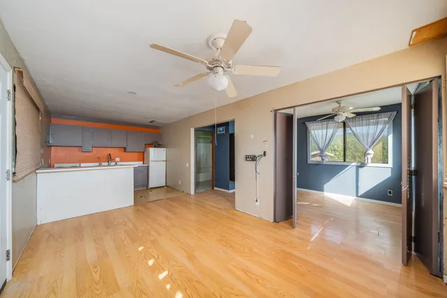 a view of a room with cabinet and a ceiling fan