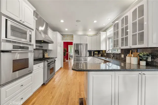 a kitchen with granite countertop white cabinets and window