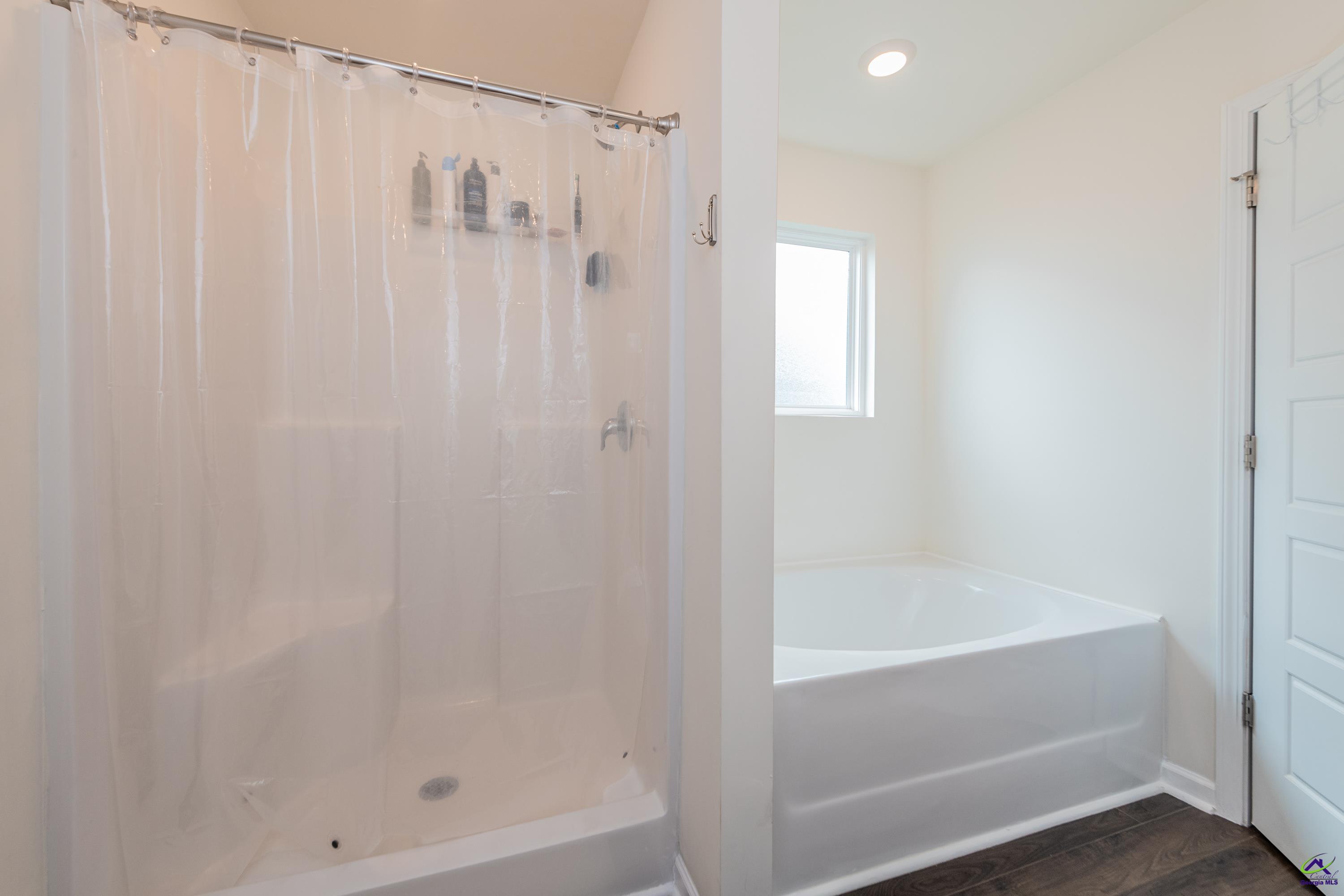 126 Farmers Way Perry, GA 31069 - Photo 18 of 39 a bathroom with a shower and a bath tub
