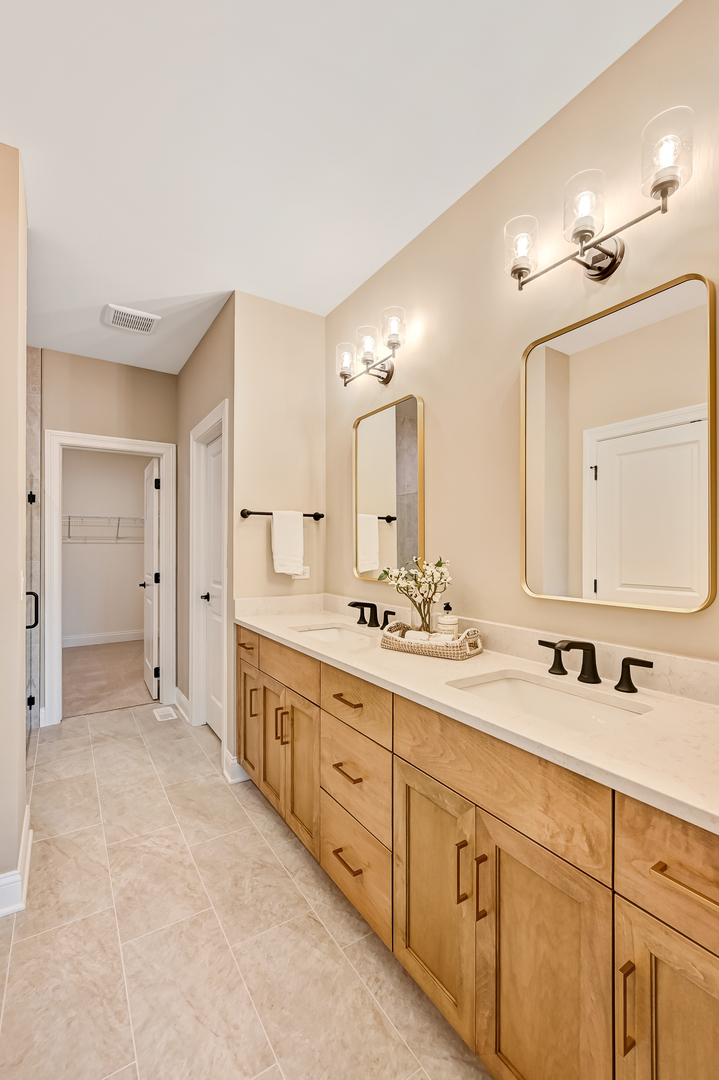 12235 Copper Ridge Drive, Unit 18 Lemont, IL 60439 - Photo 18 of 30 a spacious bathroom with a double vanity sink mirror and double