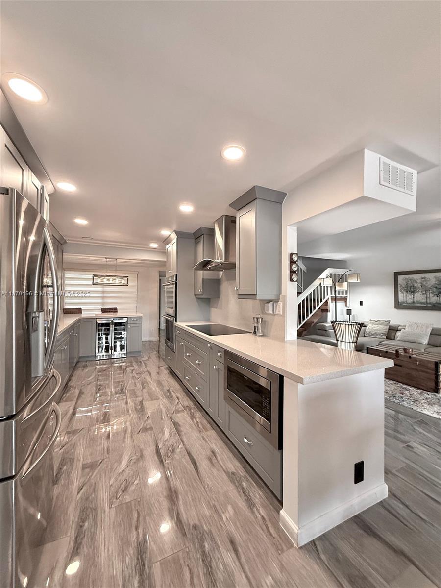 a large white kitchen with cabinets and stainless steel appliances