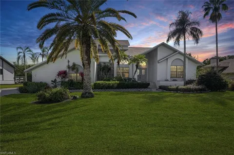a front view of house with yard and green space