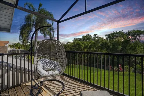 a view of a porch with wooden floor and fence