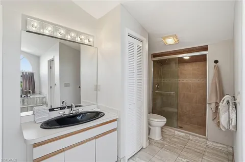 a bathroom with a double vanity sink and a large mirror