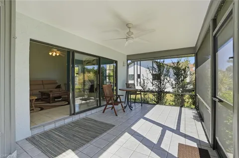 a view of a porch with a table and chairs and potted plants