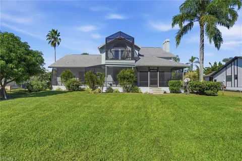 a view of a room with a large window and wooden floor