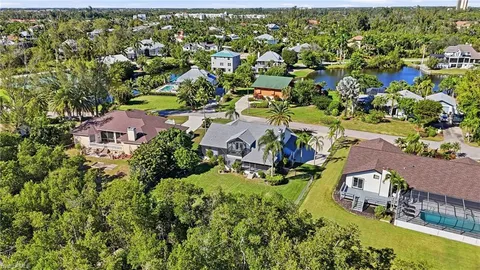 an aerial view of a residential houses with yard